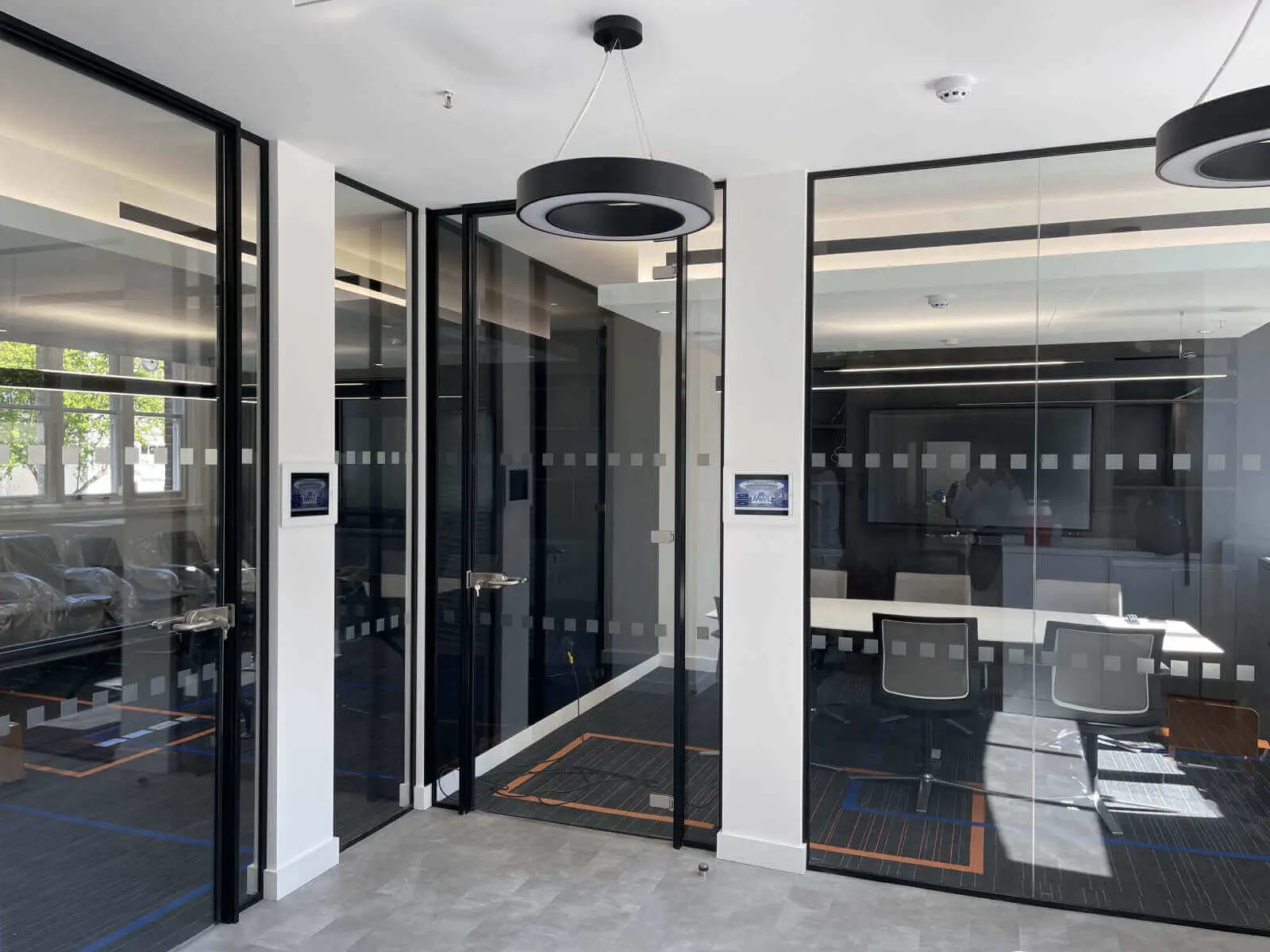 Office waiting andmeeting spaces with single glazed partiton with framed door