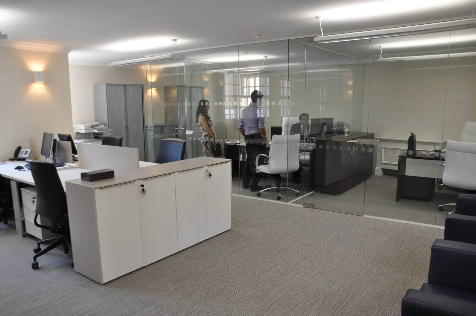 Aprirose office space with designer furniture, plasterboard ceiling, laminated wood flooring and glass partitions