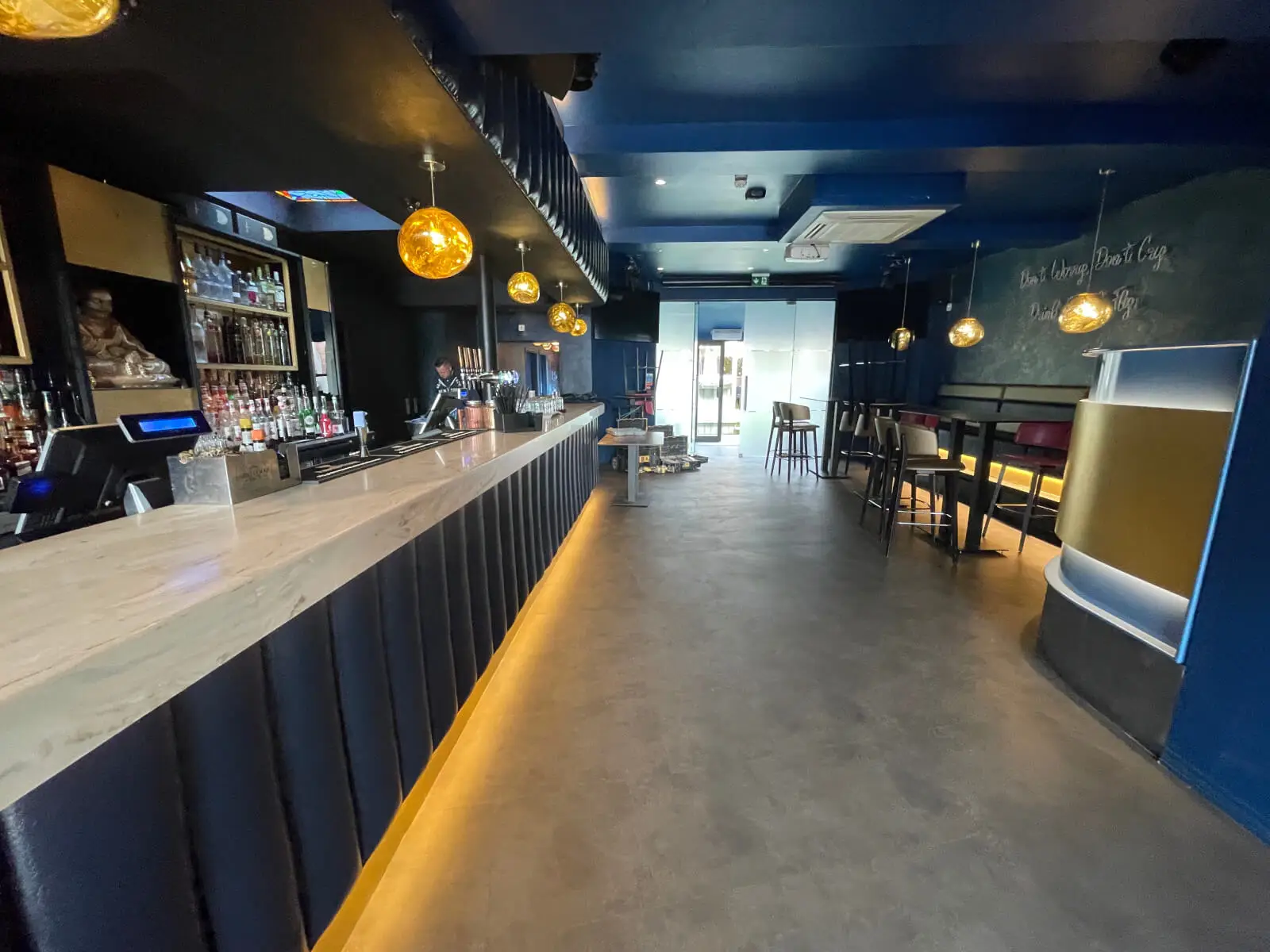 Cardamom Bar and Club with designer high tables, chairs, carpet tile flooring, and led lightings
