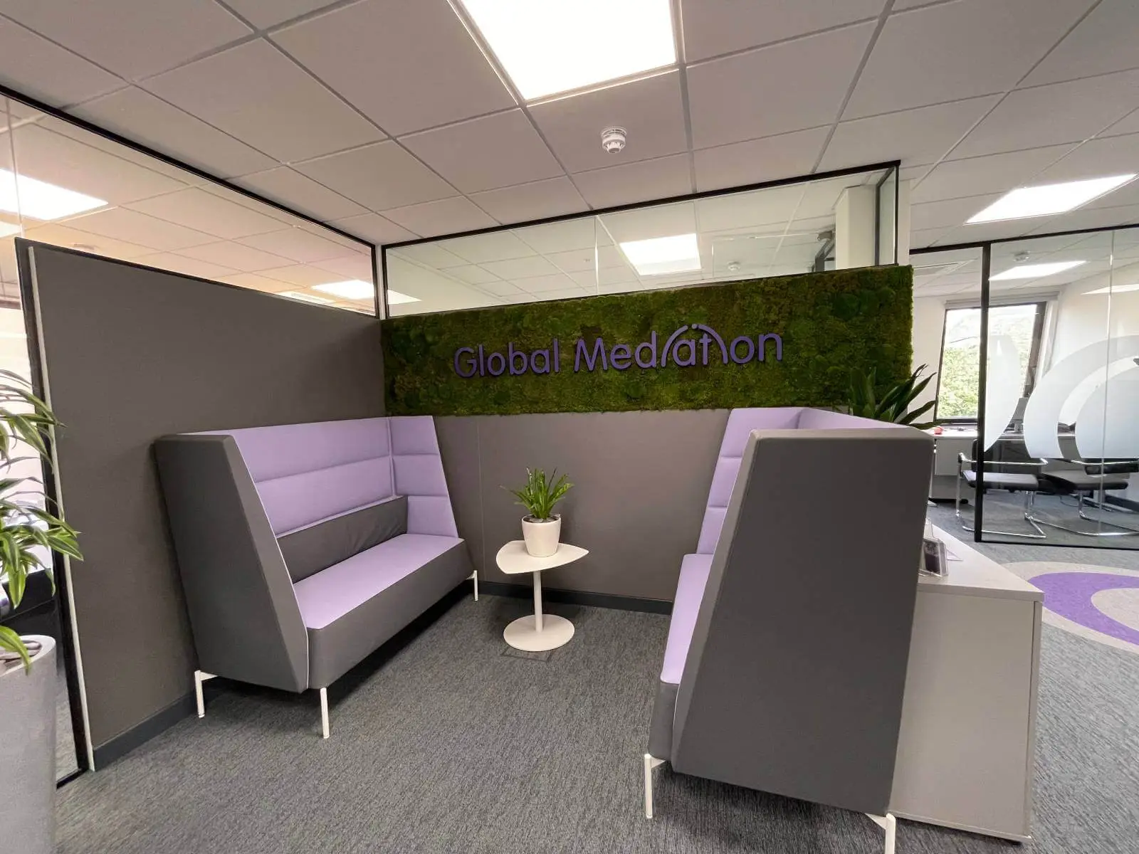 Global Mediation office space design with designer furniture, suspended grid ceiling, carpet tile flooring, and glass partitions