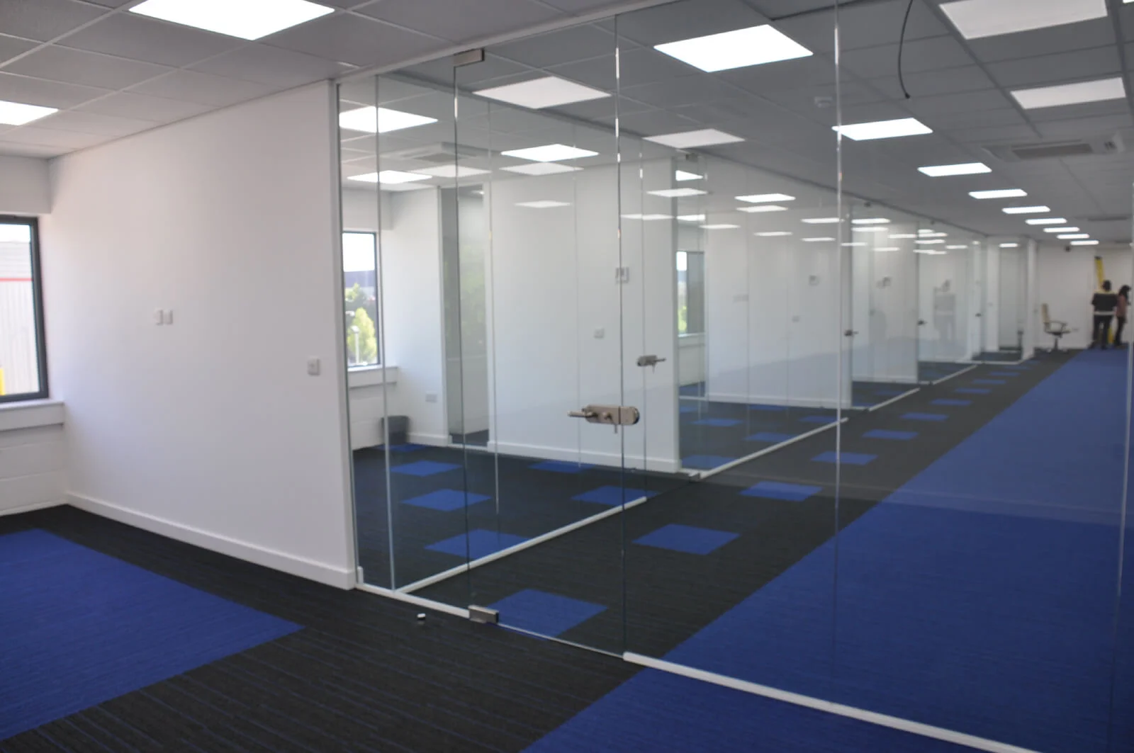 Nasco office space with designer flooring and single glazed solid stud wall glass partitions