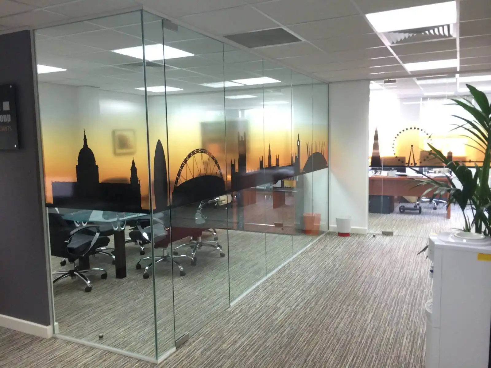 Prideview developers office space with designer furnitures and carpet tile flooring and suspended grid ceiling and frameless glass partitions screen