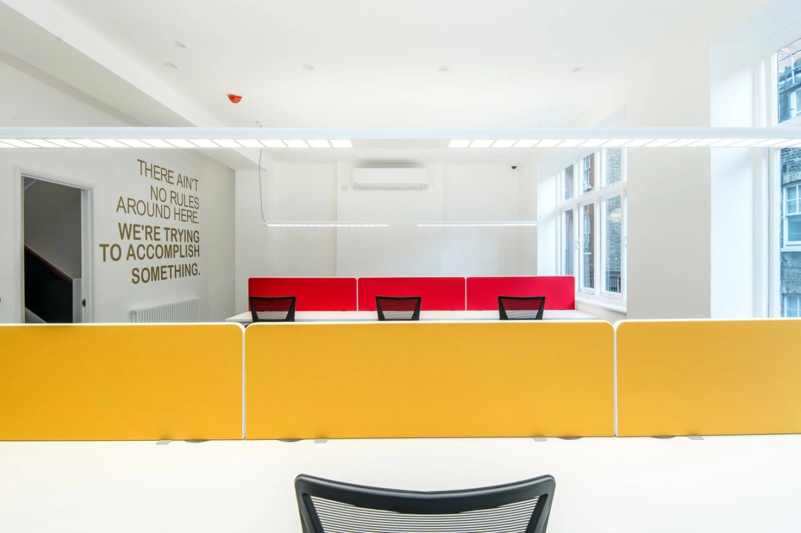 Able Prop office design with designer back to back desks with screens and chairs 11