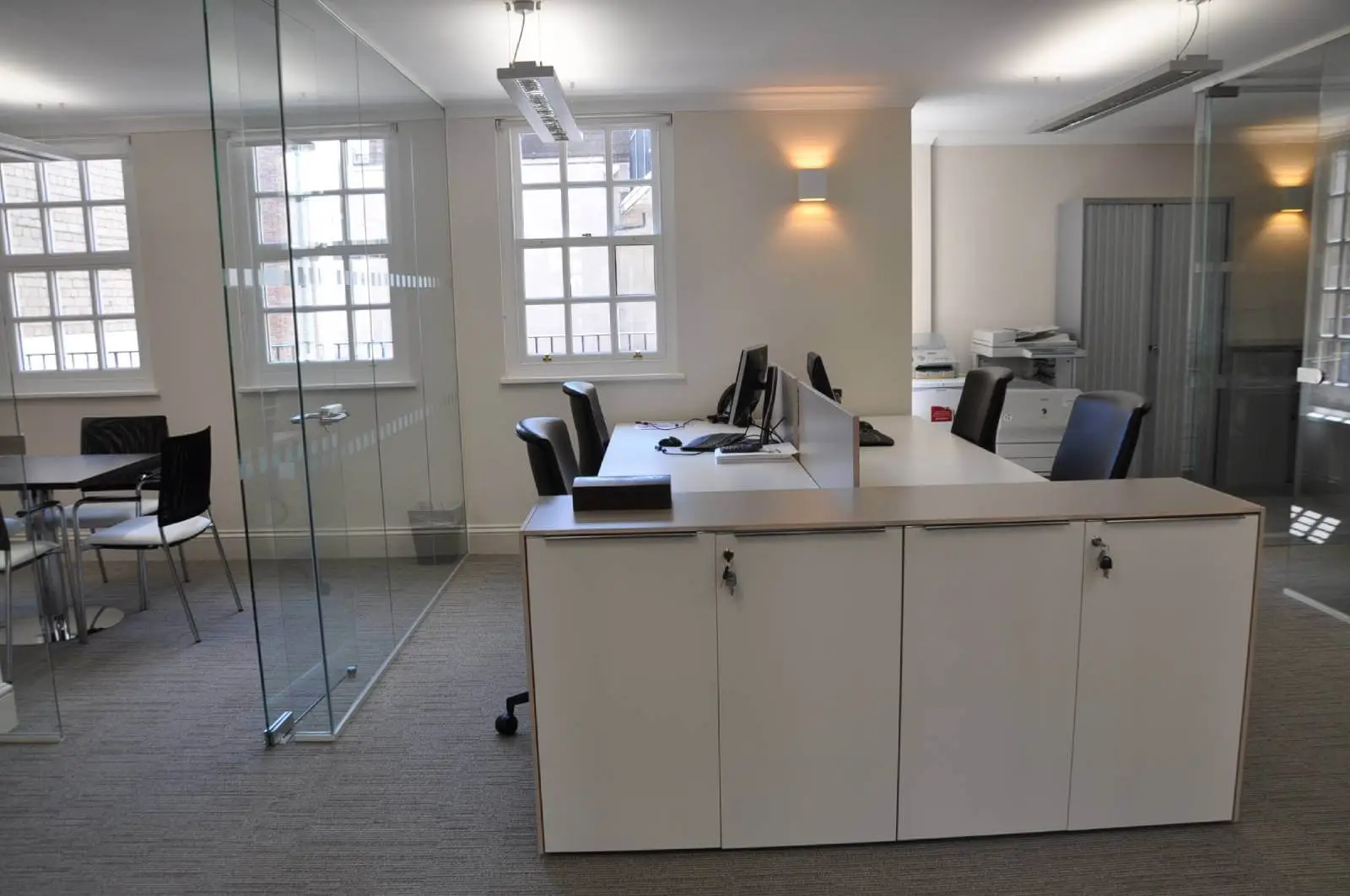 Aprirose-office-space-with-designer-furniture,-plasterboard-ceiling,-laminated-wood-flooring-and-glass-partitions 4