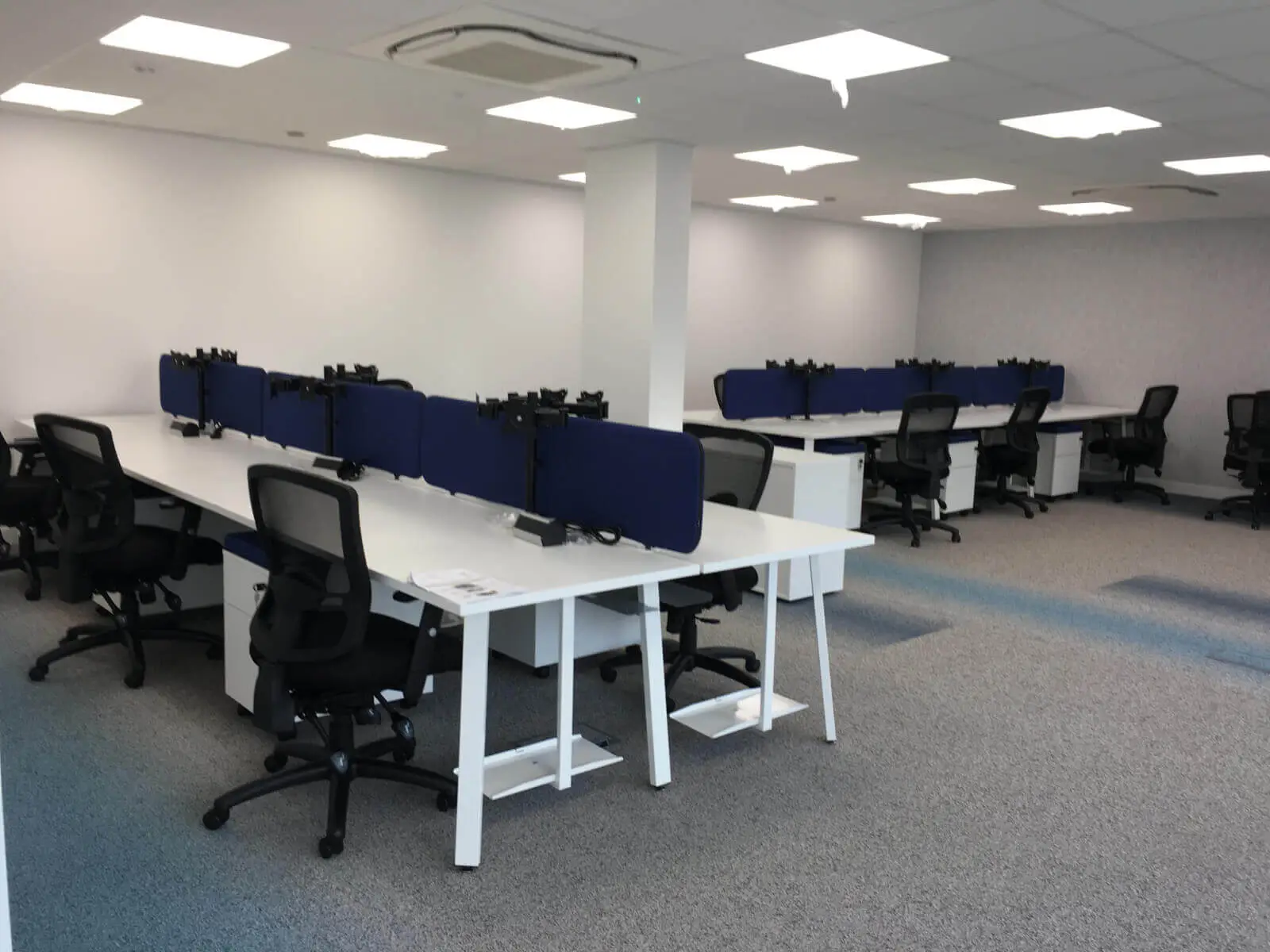 Beat Concept office space with designer back to back office desks, chiars and suspended grid ceiling 2