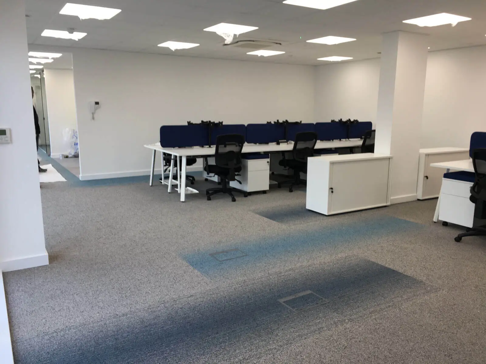 Beat Concept office space with designer back to back office desks, chiars and suspended grid ceiling 3