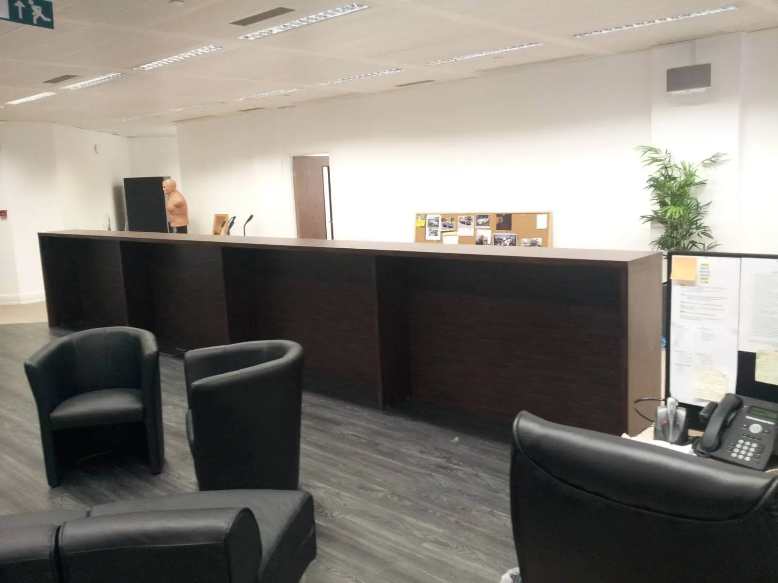 Bordeux office space with designer furniture, laminated wood floor, suspended grid ceiling, and glass partitions 1