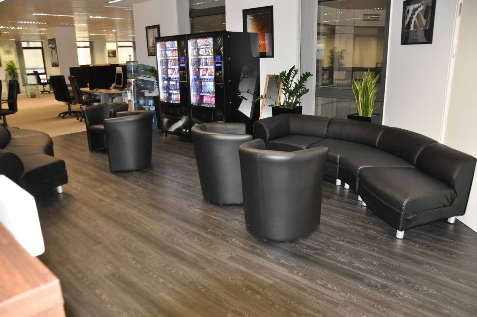 Bordeux office space with designer furniture, laminated wood floor, suspended grid ceiling, and glass partitions 12