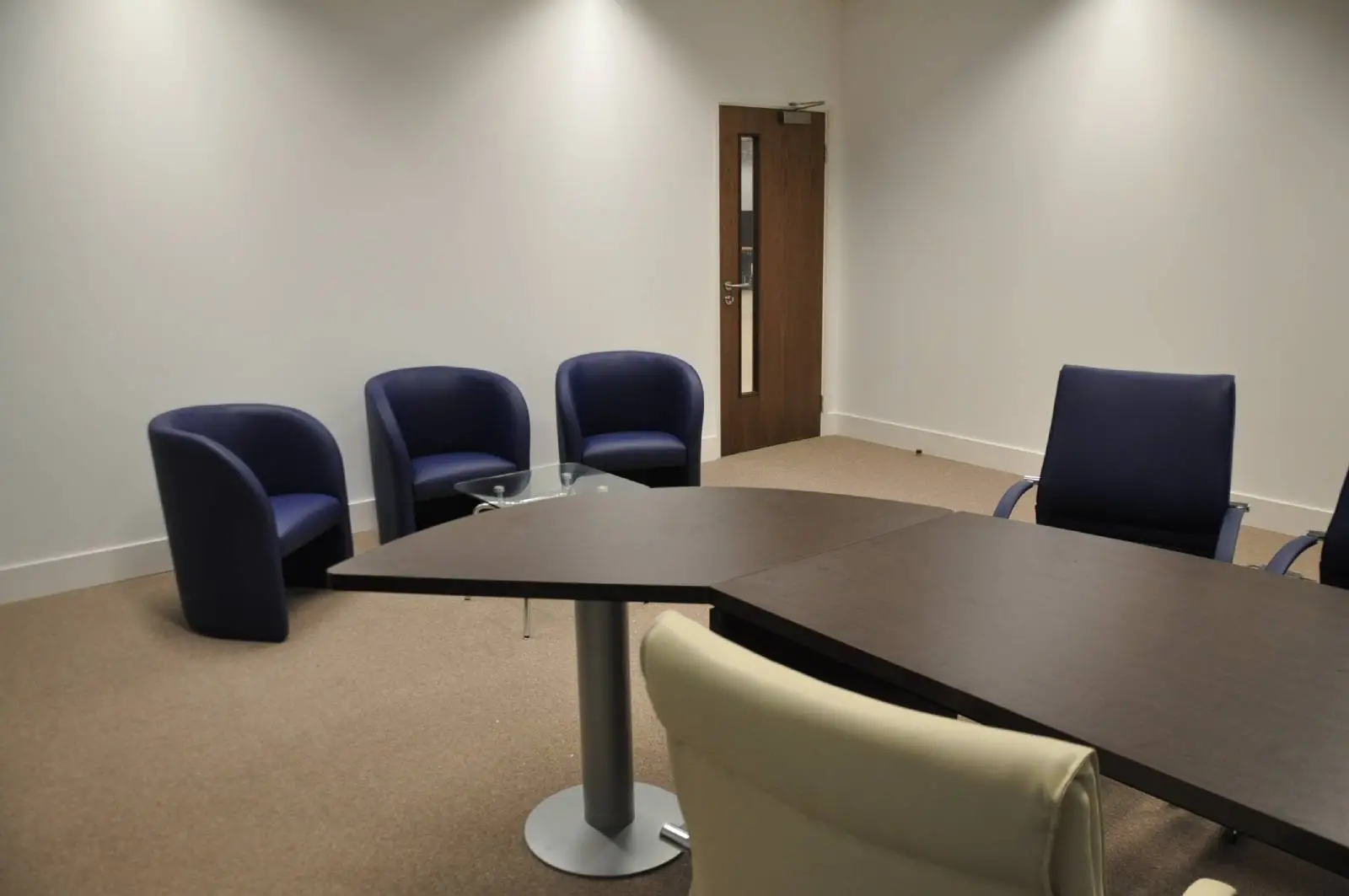 Bordeux office space with designer furniture, laminated wood floor, suspended grid ceiling, and glass partitions 13