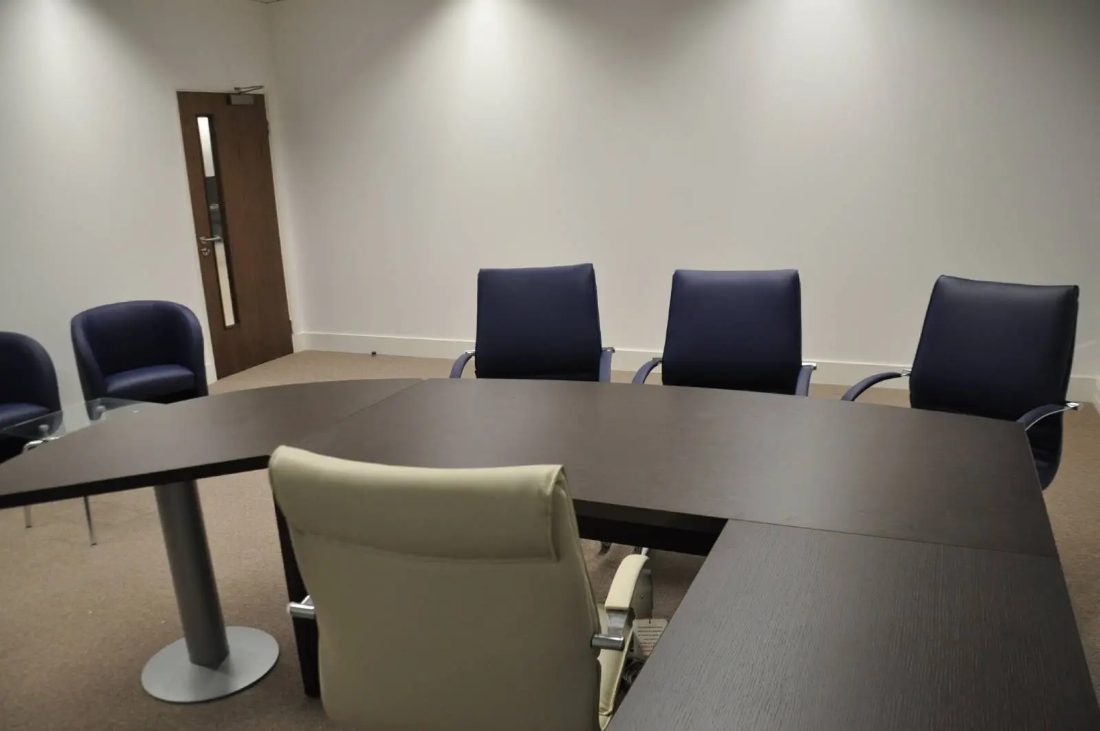 Bordeux office space with designer furniture, laminated wood floor, suspended grid ceiling, and glass partitions 15
