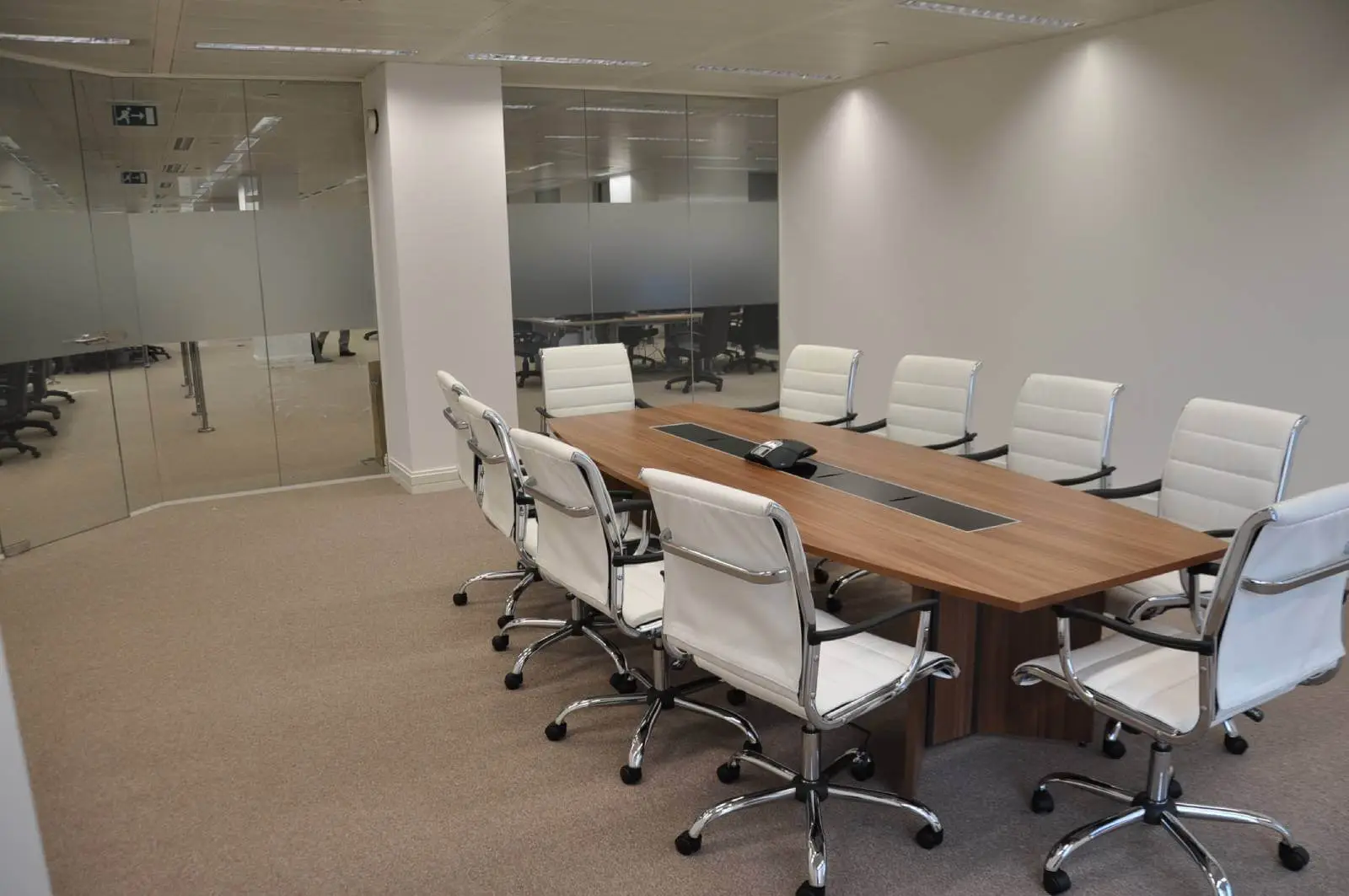 Bordeux office space with designer furniture, laminated wood floor, suspended grid ceiling, and glass partitions 19