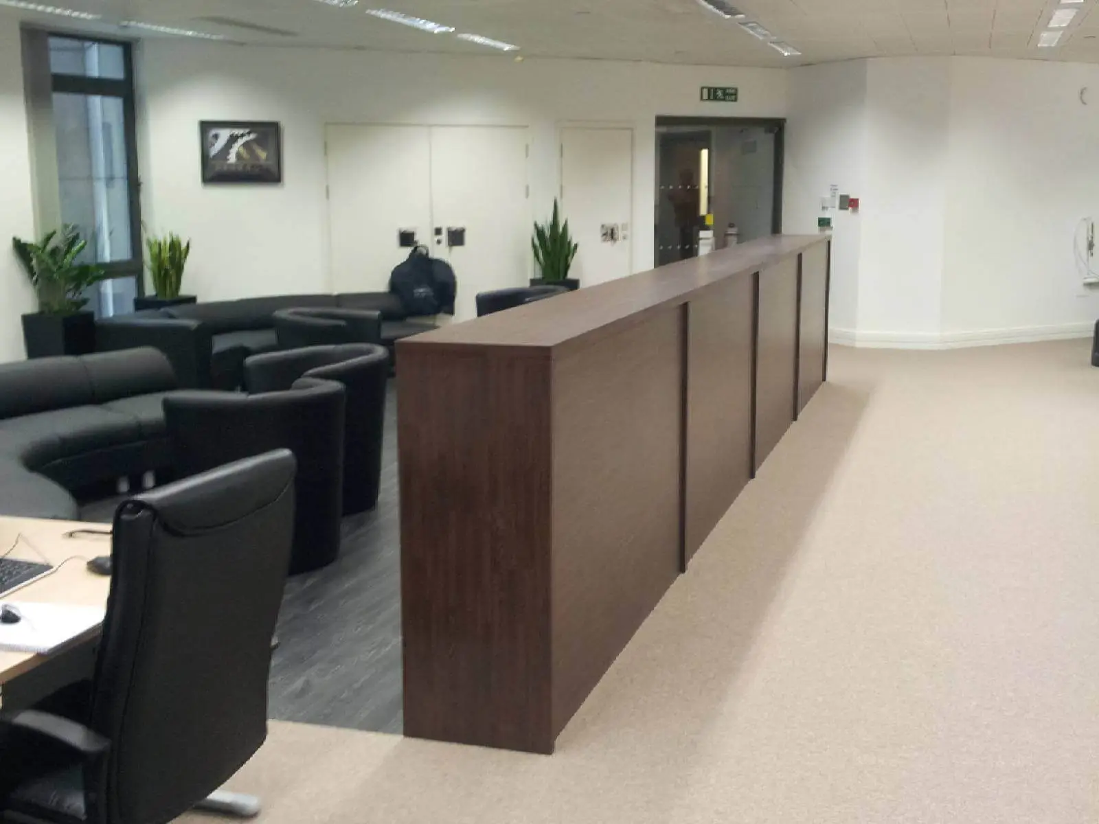 Bordeux office space with designer furniture, laminated wood floor, suspended grid ceiling, and glass partitions 2