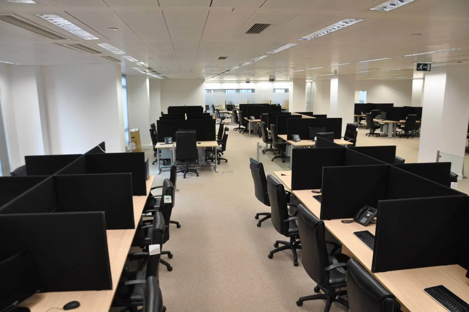 Bordeux office space with designer furniture, laminated wood floor, suspended grid ceiling, and glass partitions 5