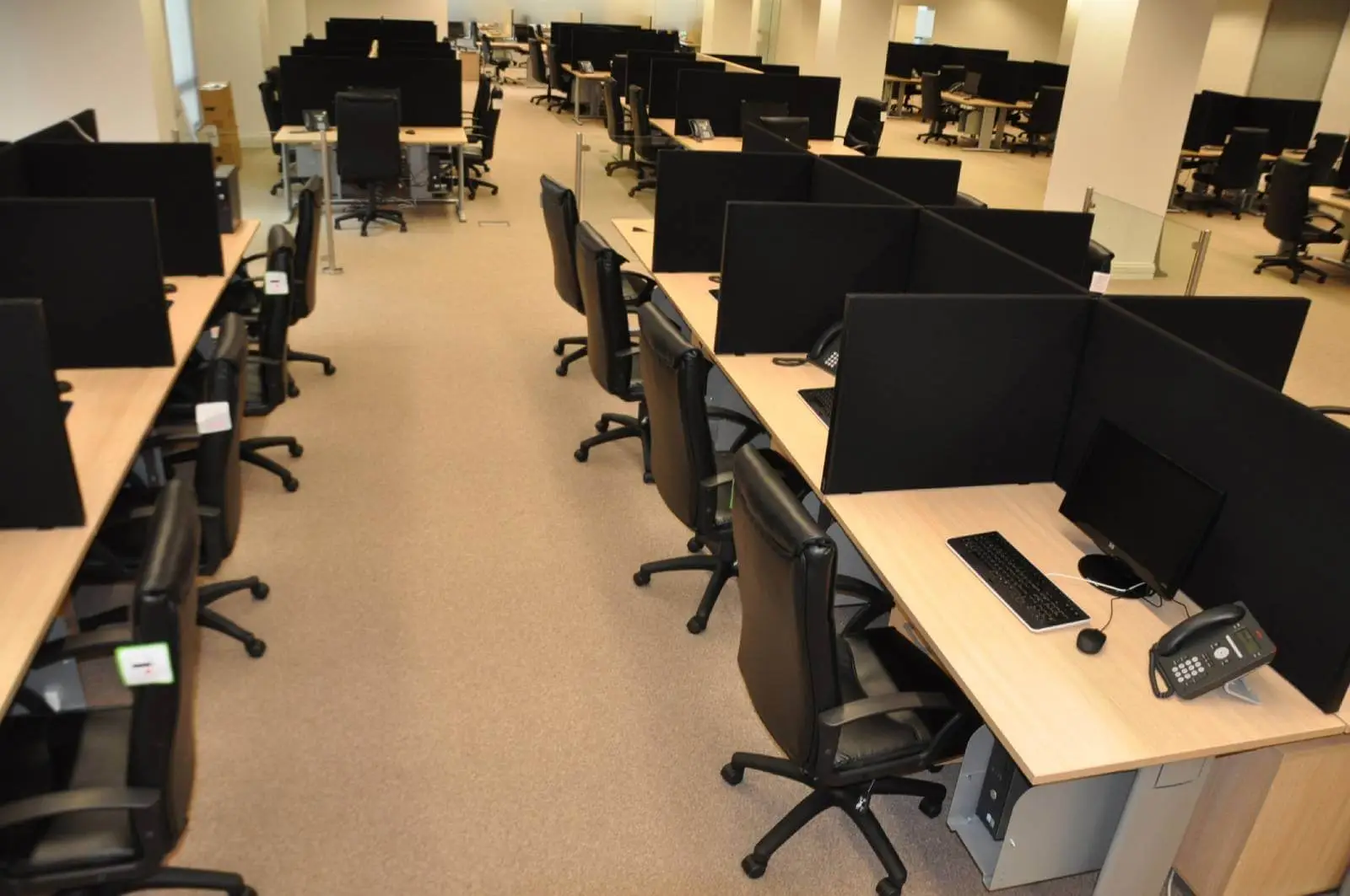 Bordeux office space with designer furniture, laminated wood floor, suspended grid ceiling, and glass partitions 6