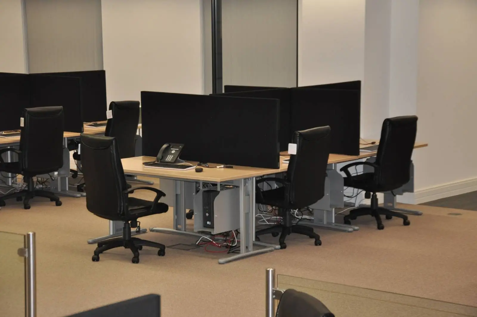 Bordeux office space with designer furniture, laminated wood floor, suspended grid ceiling, and glass partitions 7