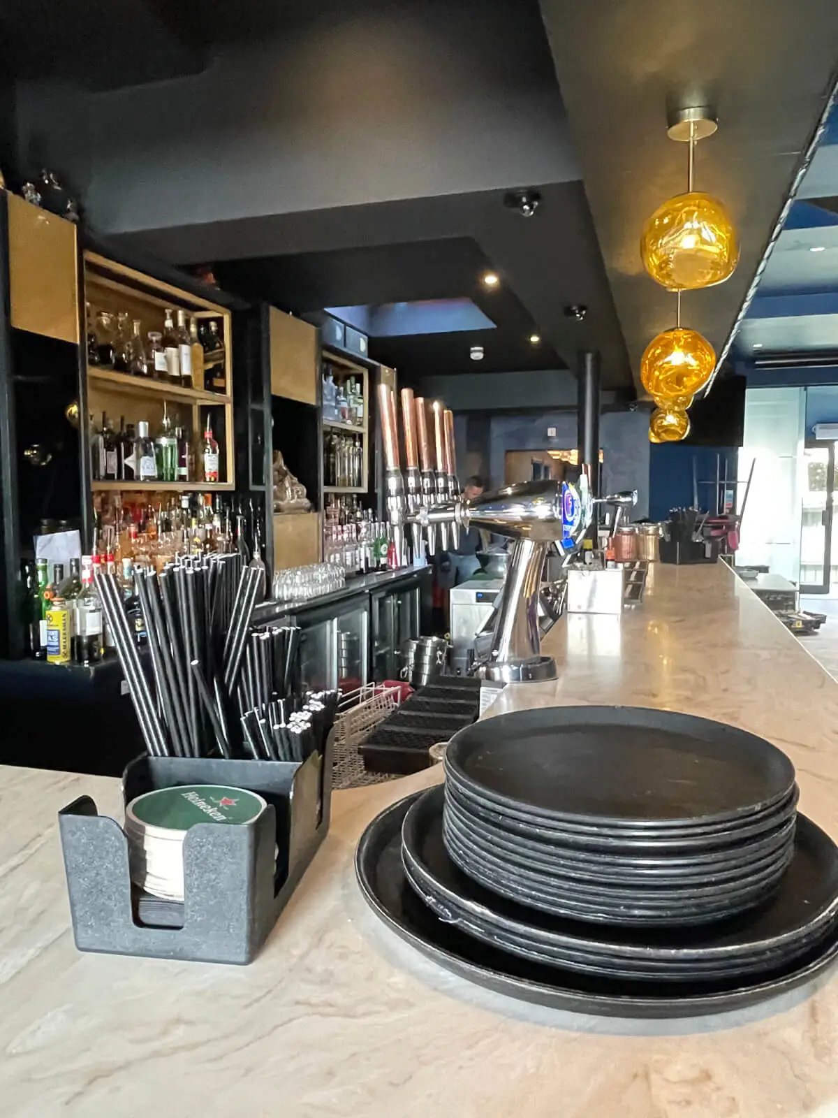 Cardamom Bar and Club with designer high tables, chairs, carpet tile flooring, and led lightings 17