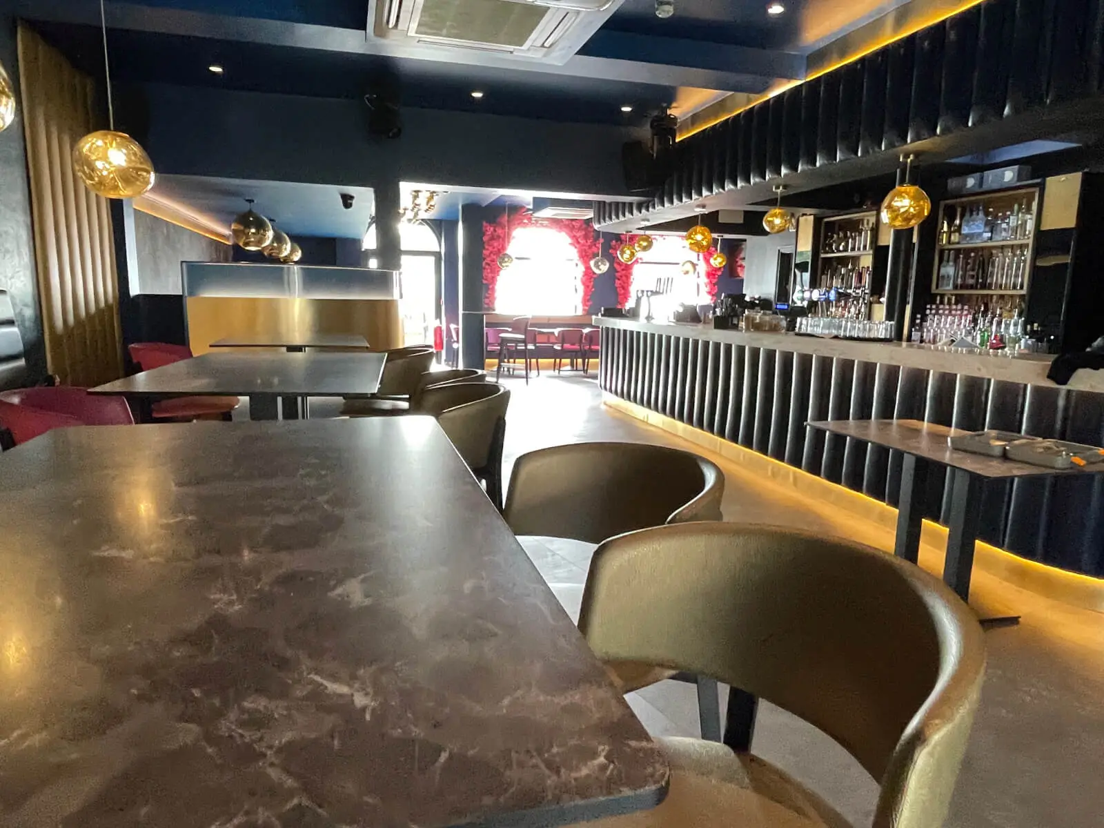 Cardamom Bar and Club with designer high tables, chairs, carpet tile flooring, and led lightings 22