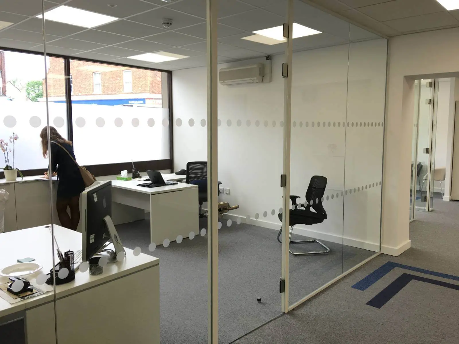 Care Expertise health care space with designer furniture, suspended grid ceiling, carpet tile flooring and glass partitions 1