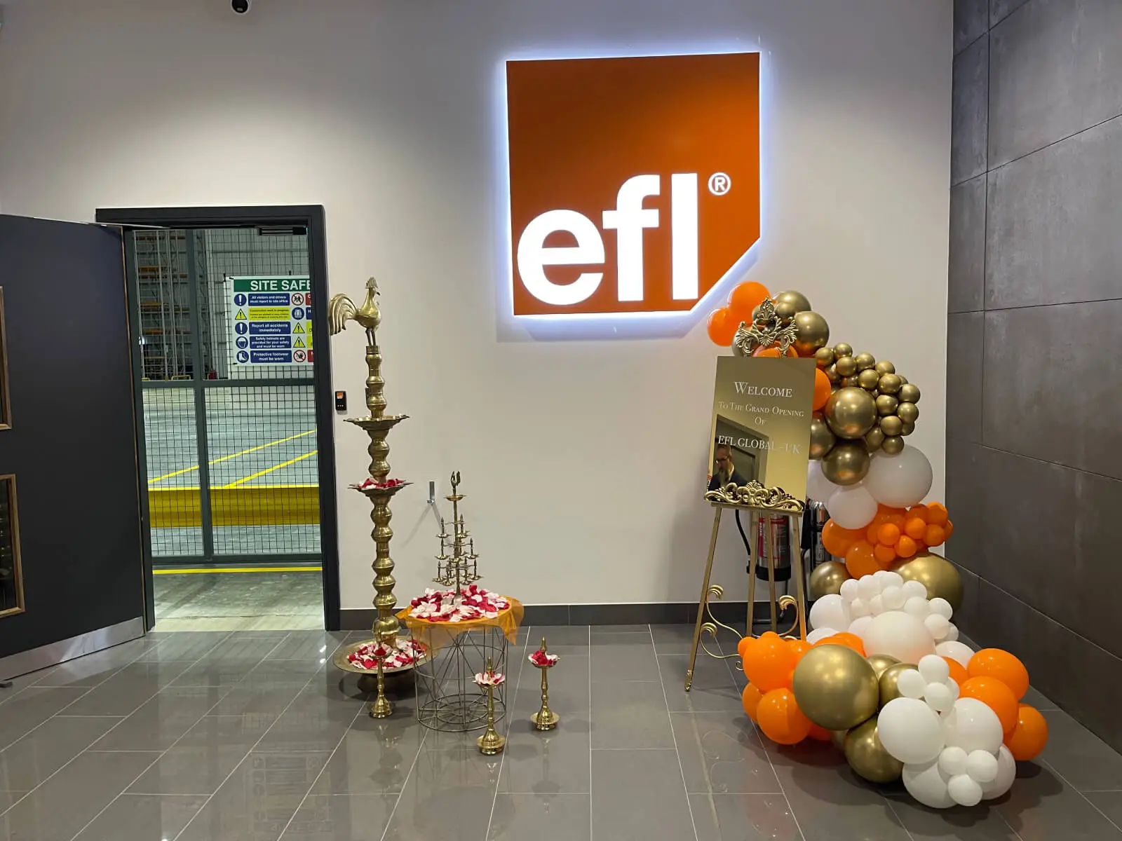EFL office space with designer back to back desks, chairs, laminated wood flooring, suspended grid ceiling and glass partitions 7