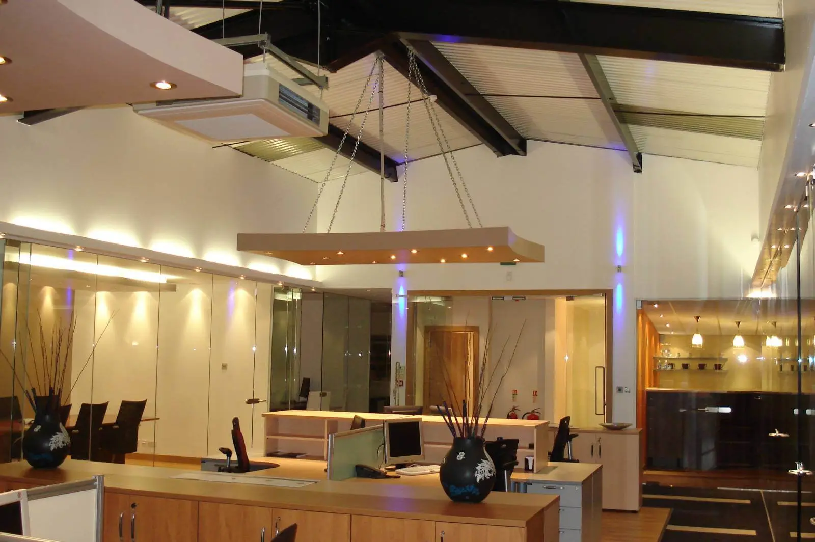 GXI office unit D space design with designer furniture, along with flooring, ceiling, and glass partitions 9