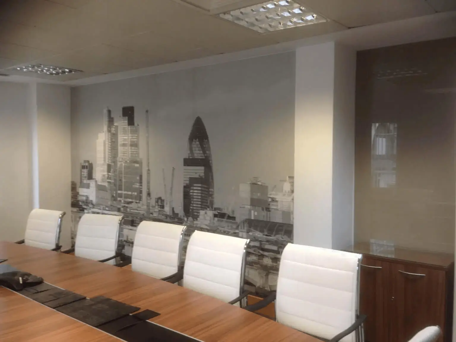 hcig office work space with designer furniture, glass partitions, suspended grid ceiling, and designer flooring 10