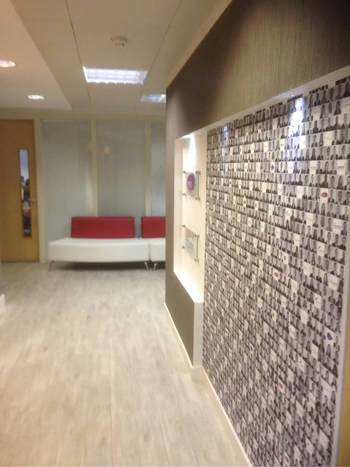 hcig office work space with designer furniture, glass partitions, suspended grid ceiling, and designer flooring 13