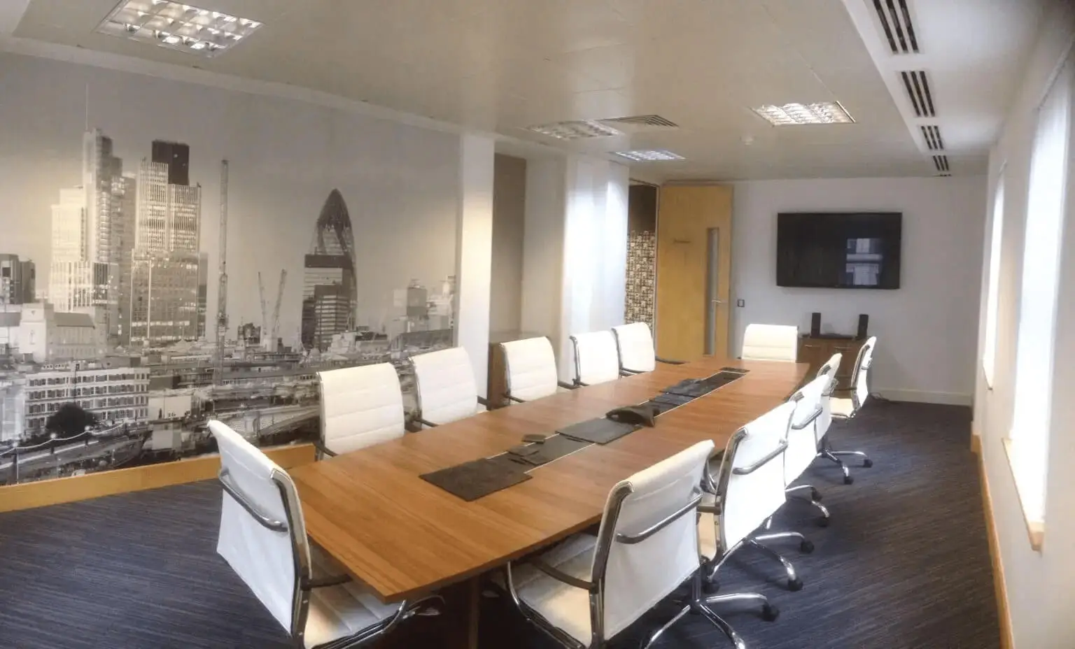hcig office work space with designer furniture, glass partitions, suspended grid ceiling, and designer flooring 3