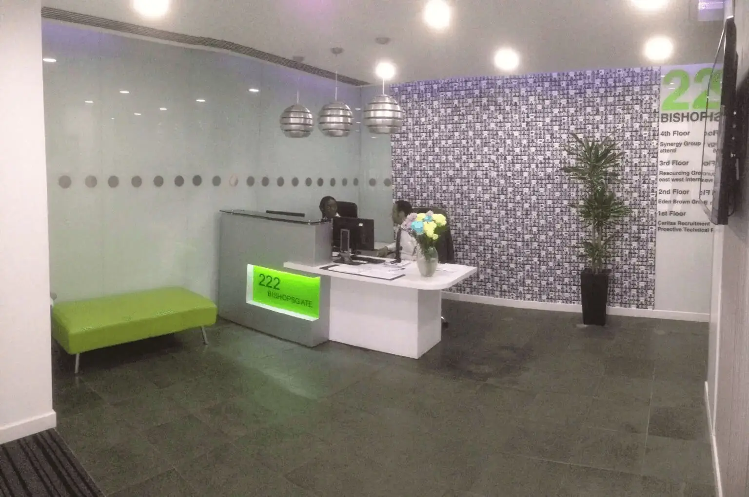 hcig office work space with designer furniture, glass partitions, suspended grid ceiling, and designer flooring 4