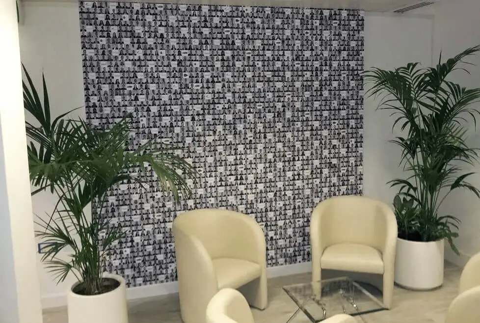 hcig office work space with designer furniture, glass partitions, suspended grid ceiling, and designer flooring 5