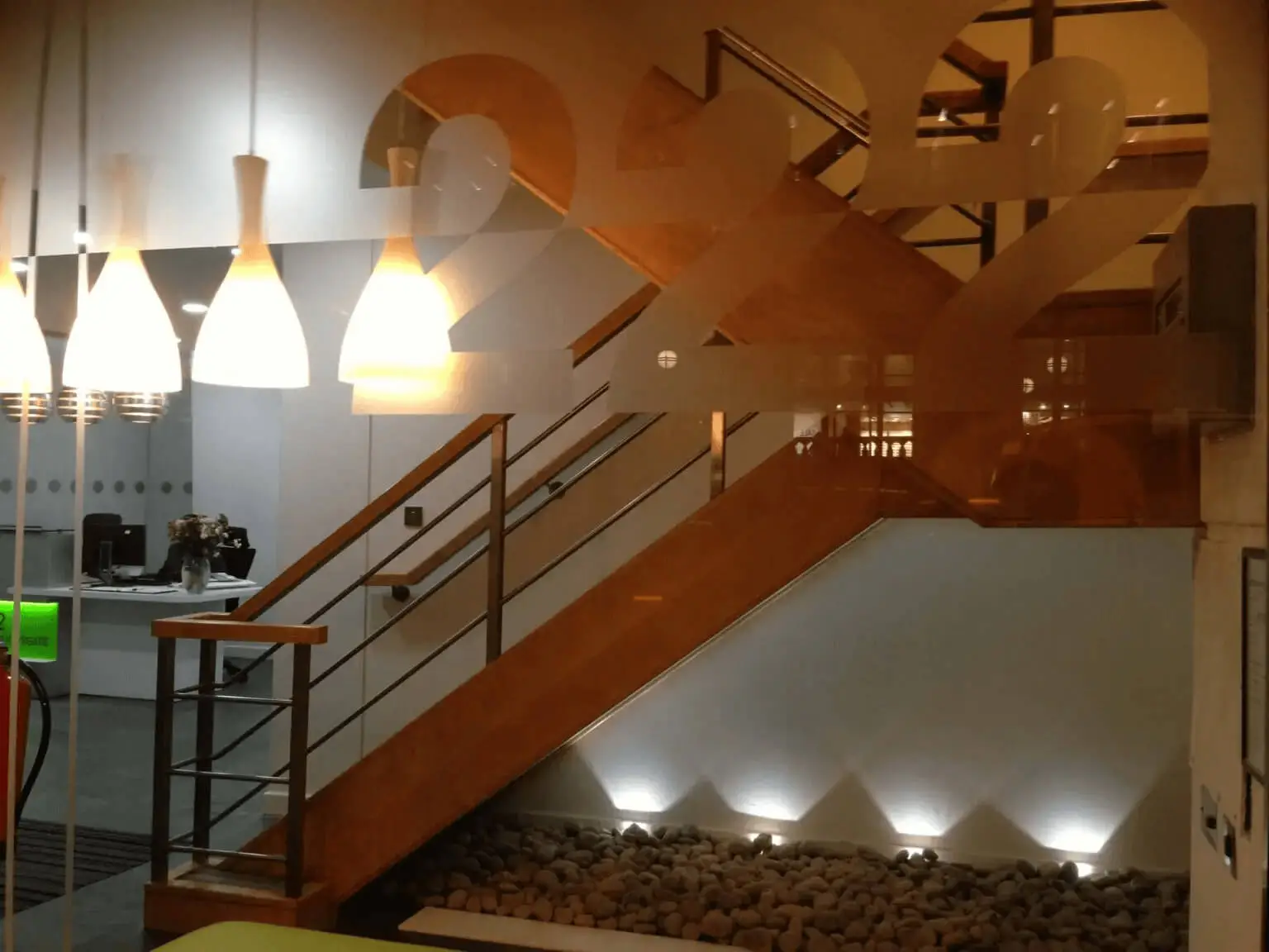 hcig office work space with designer furniture, glass partitions, suspended grid ceiling, and designer flooring 6
