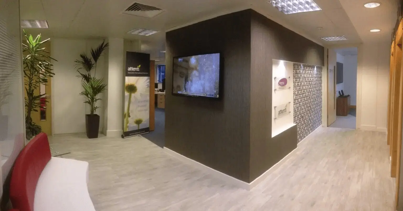 hcig office work space with designer furniture, glass partitions, suspended grid ceiling, and designer flooring 8