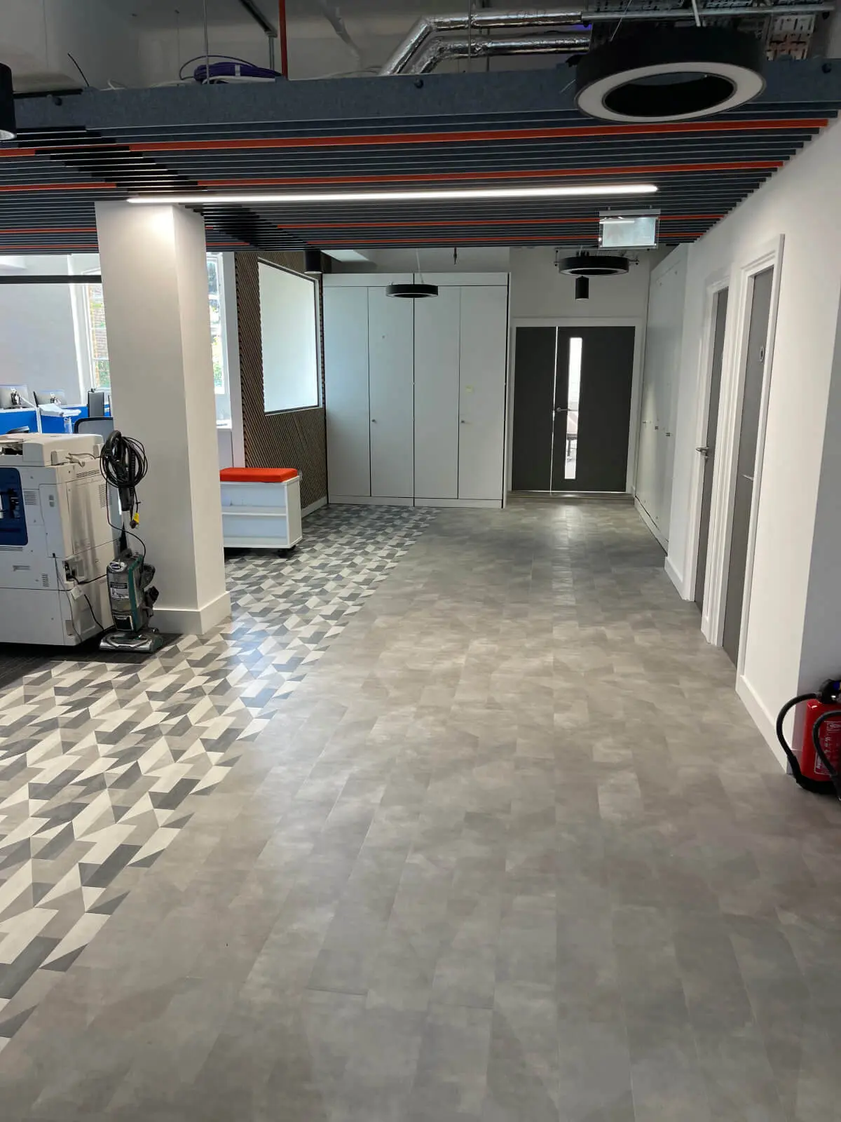 Mendik Waring office space design with designer flooring, acoustic ceiling and black framed glass partitions 16