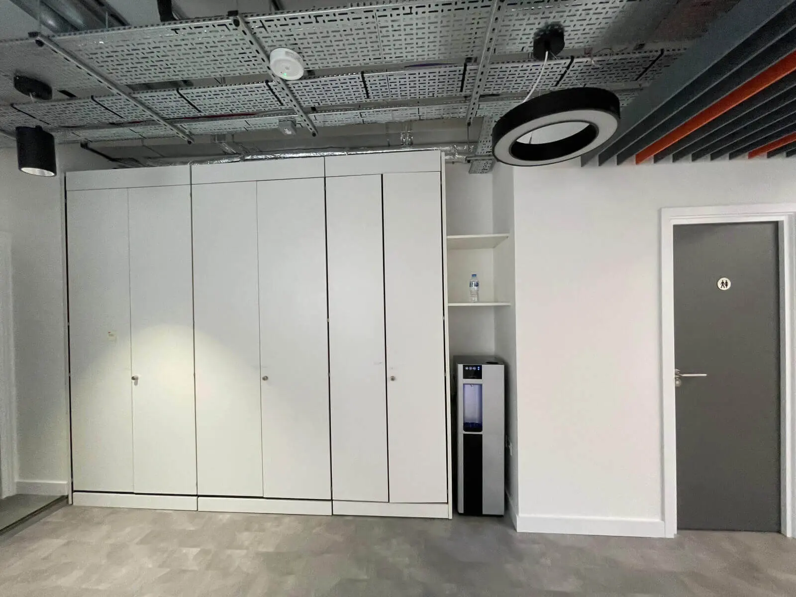 Mendik Waring office space design with designer flooring, acoustic ceiling and black framed glass partitions 17