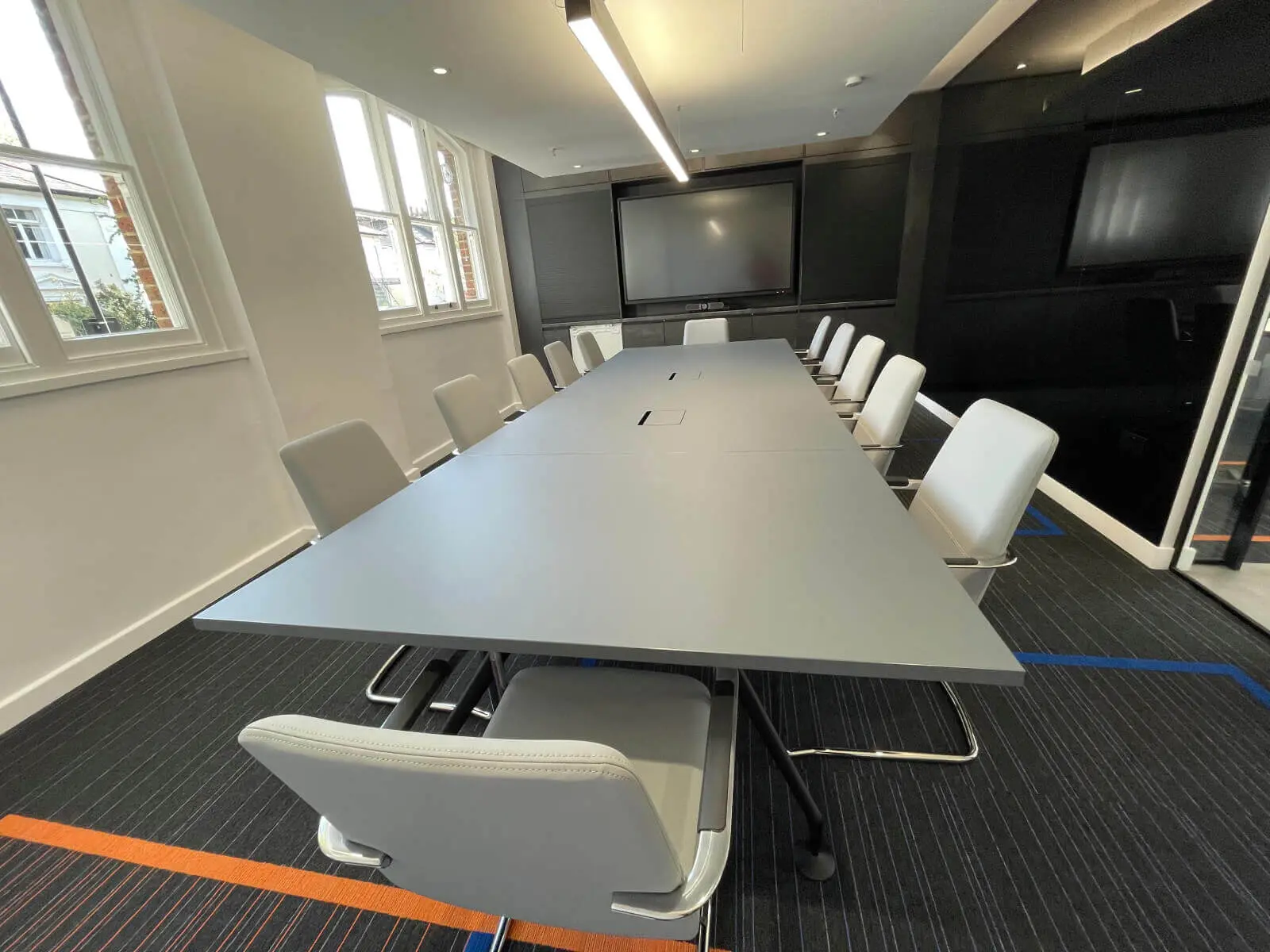 Mendik Waring office space design with designer flooring, acoustic ceiling and black framed glass partitions 20
