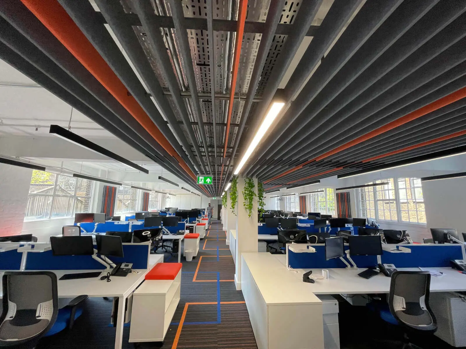 Mendik Waring office space design with designer flooring, acoustic ceiling and black framed glass partitions 5