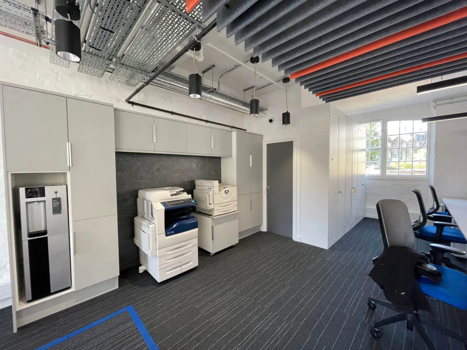 Mendik Waring office space design with designer flooring, acoustic ceiling and black framed glass partitions 6