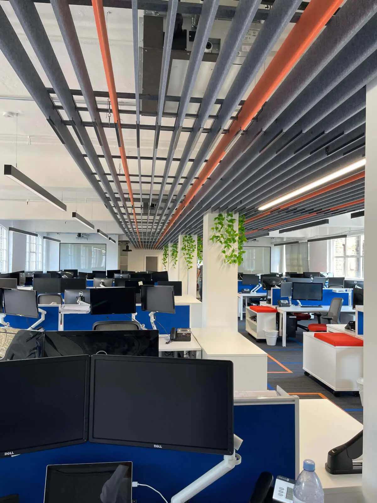 Mendik Waring office space design with designer flooring, acoustic ceiling and black framed glass partitions 7