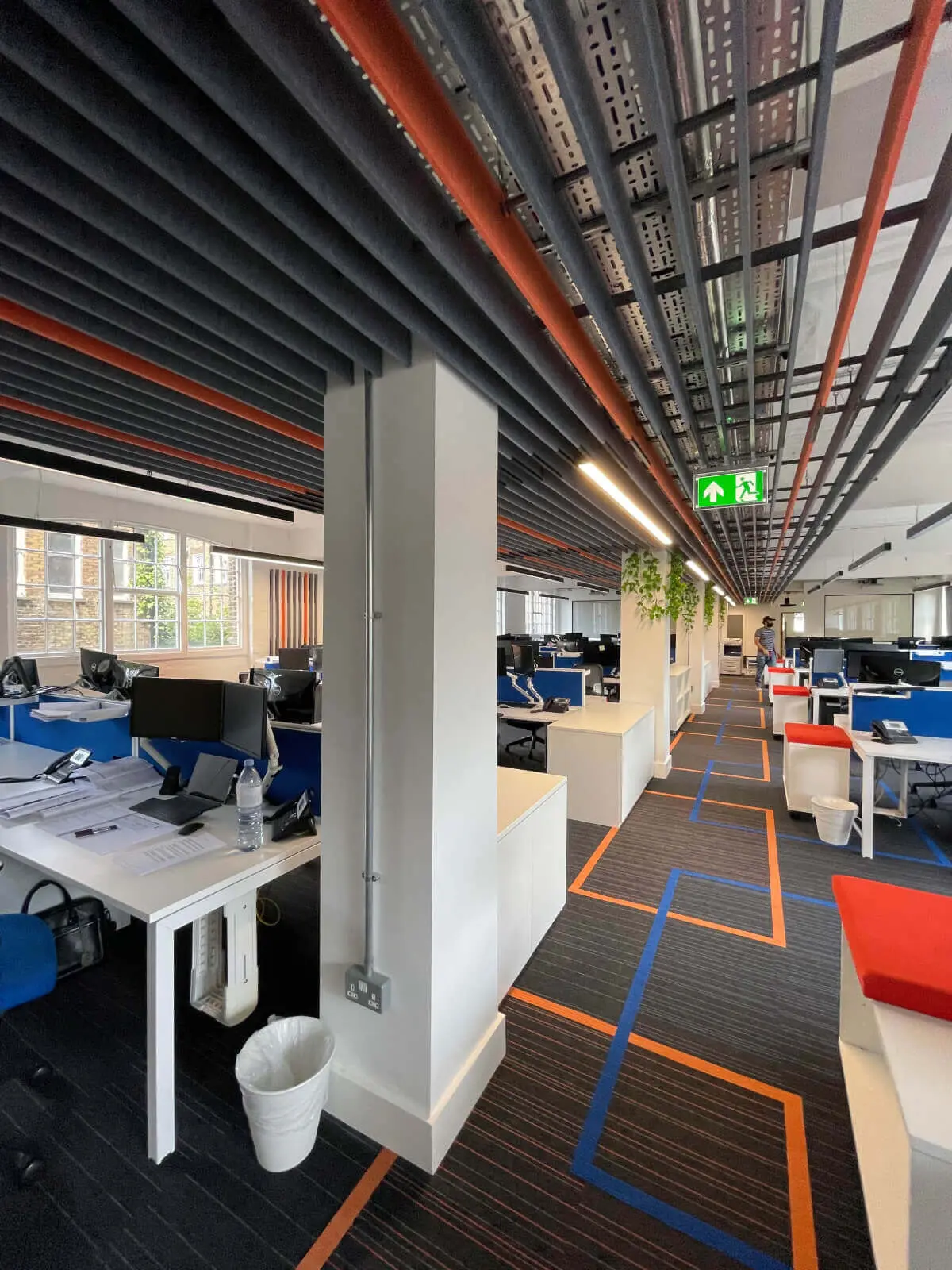 Mendik Waring office space design with designer flooring, acoustic ceiling and black framed glass partitions 8