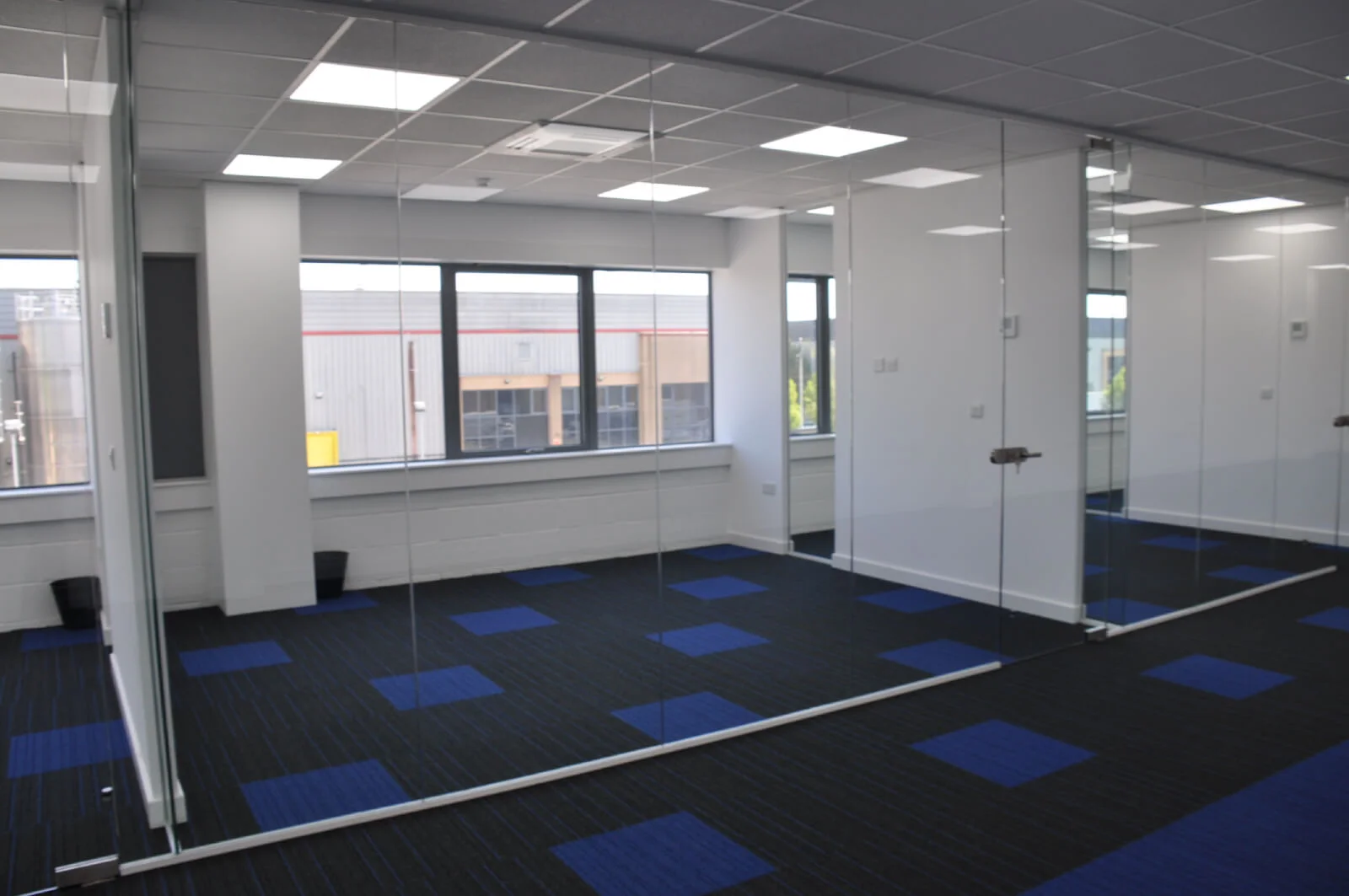 Nasco office space with designer flooring and single glazed solid stud wall glass partitions 1