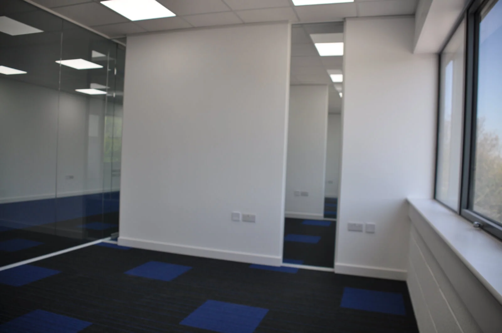 Nasco office space with designer flooring and single glazed solid stud wall glass partitions 10