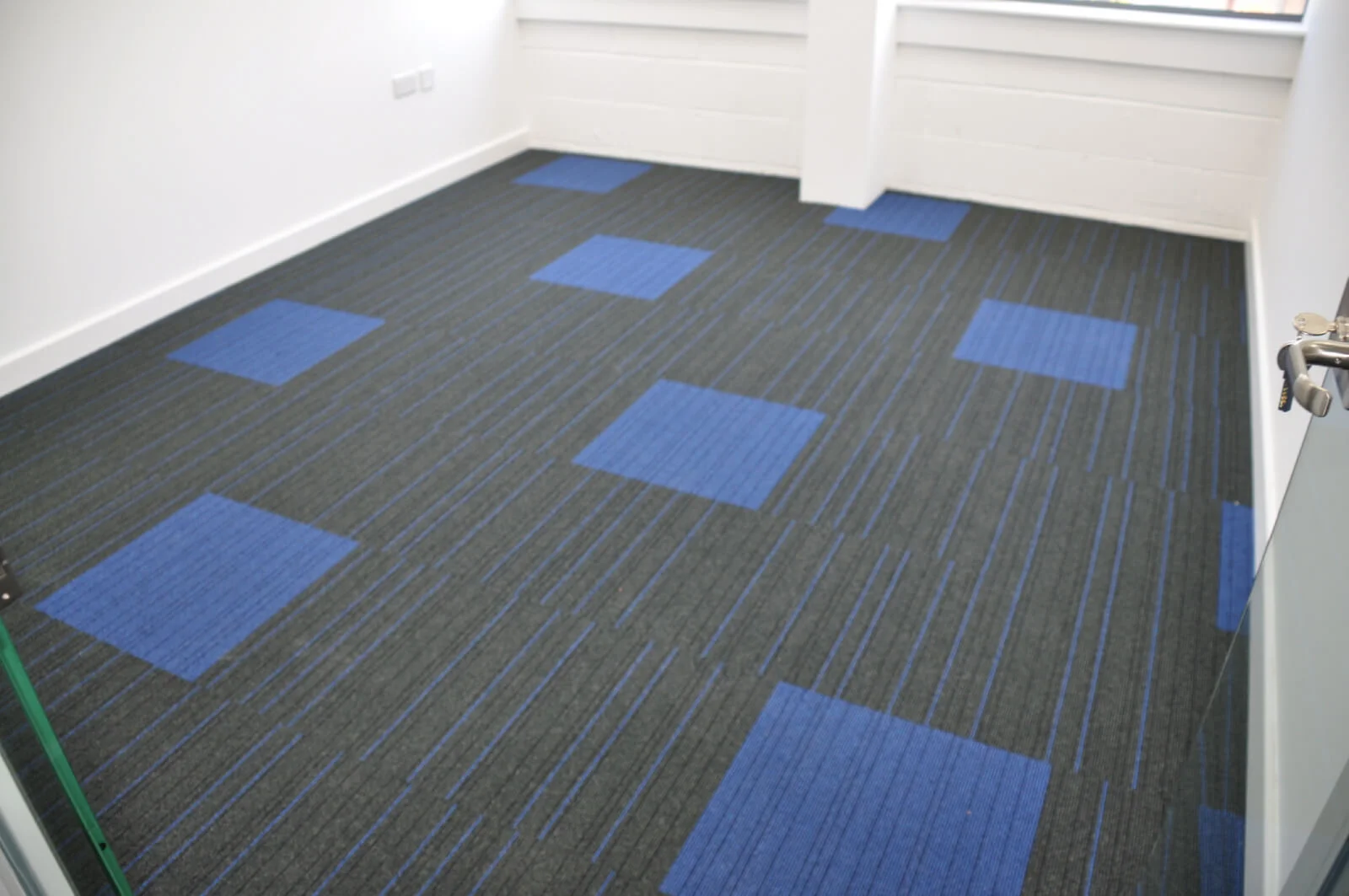 Nasco office space with designer flooring and single glazed solid stud wall glass partitions 13