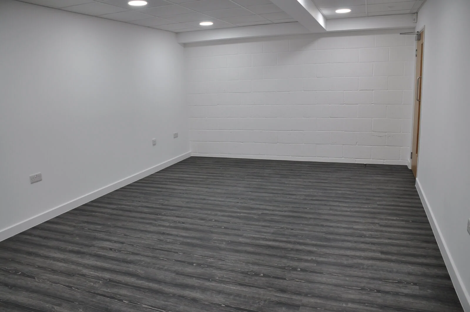 Nasco office space with designer flooring and single glazed solid stud wall glass partitions 17