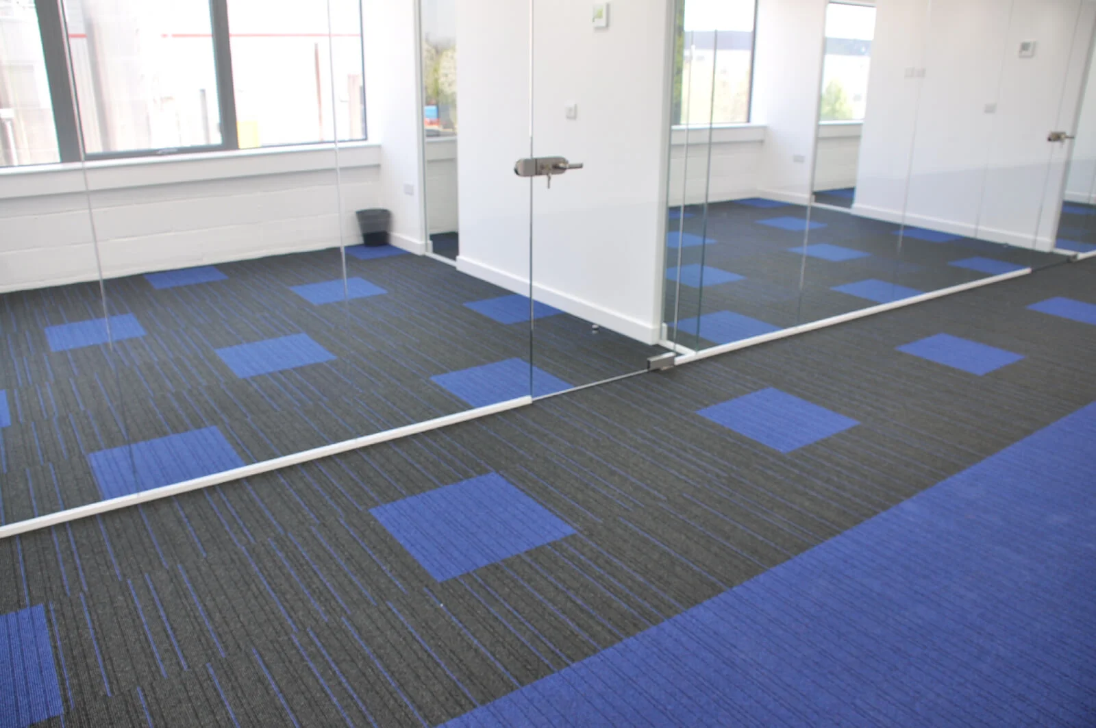 Nasco office space with designer flooring and single glazed solid stud wall glass partitions 2