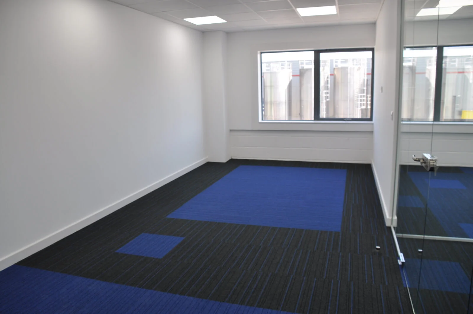 Nasco office space with designer flooring and single glazed solid stud wall glass partitions 4