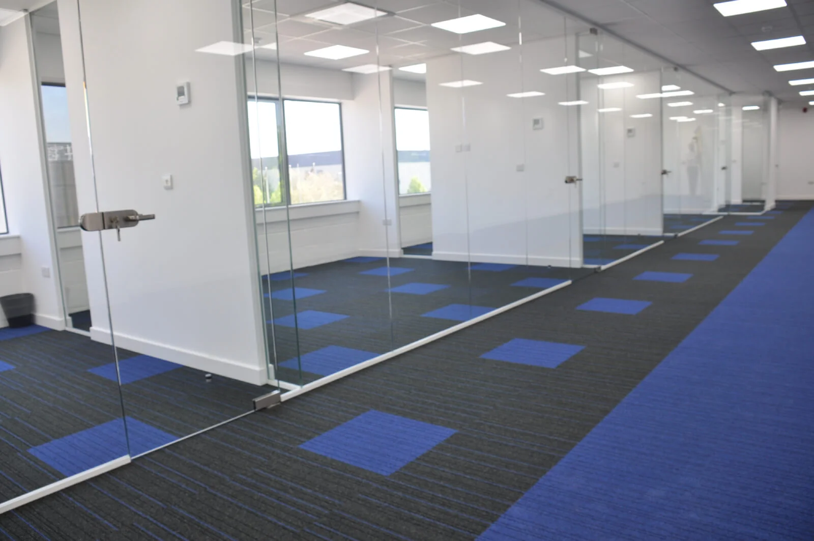 Nasco office space with designer flooring and single glazed solid stud wall glass partitions 7