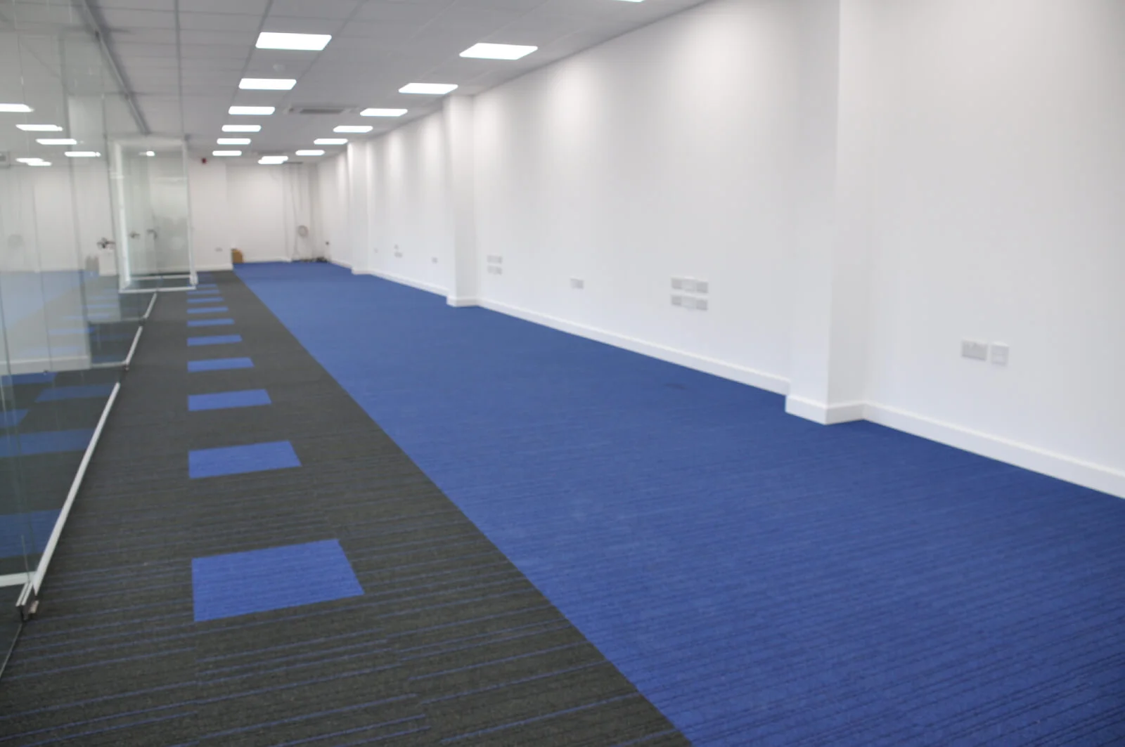 Nasco office space with designer flooring and single glazed solid stud wall glass partitions 8