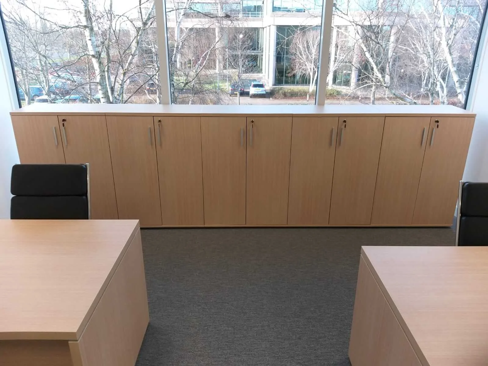 Oppo office space with designer single and back to back desks chairs and glass partitions 1
