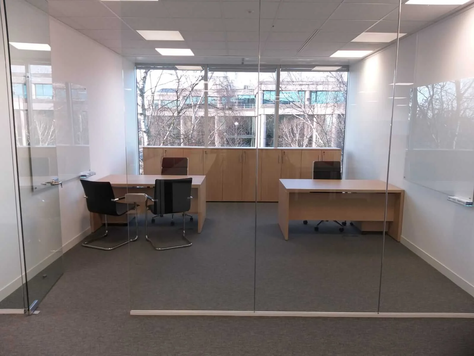 Oppo office space with designer single and back to back desks chairs and glass partitions 5