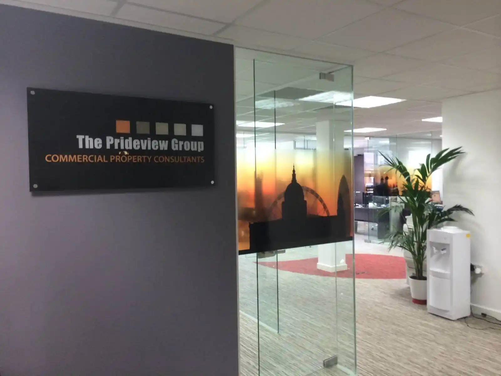 Prideview developers office space with designer furnitures and carpet tile flooring and suspended grid ceiling and frameless glass partitions screen 3