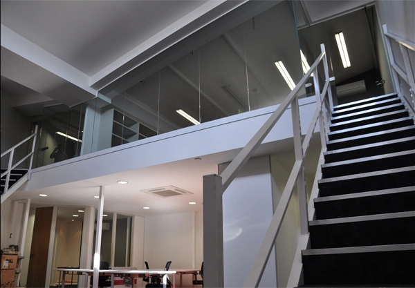 Simon Wang office space with designer furniture, flooring, suspended grid celing and glass partitions 9
